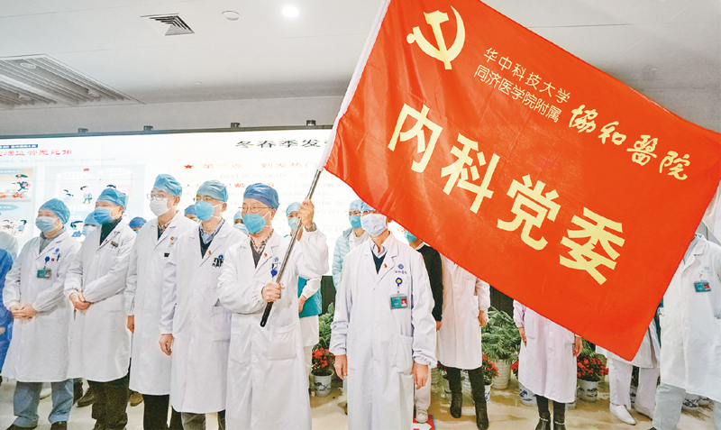 2020年1月22日,华中科技大学同济医学院附属协和医院内科30余名医务人员组成抗击新冠肺炎突击队,投入到协和医院对口支持的发热定点医院——武汉红十字会医院的工作中去。图为医务人员宣誓成立突击队。 新华社记者 程敏/摄